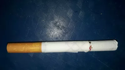 Me vino un cigarrillo envuelta en cinta y arriva en papelillo
